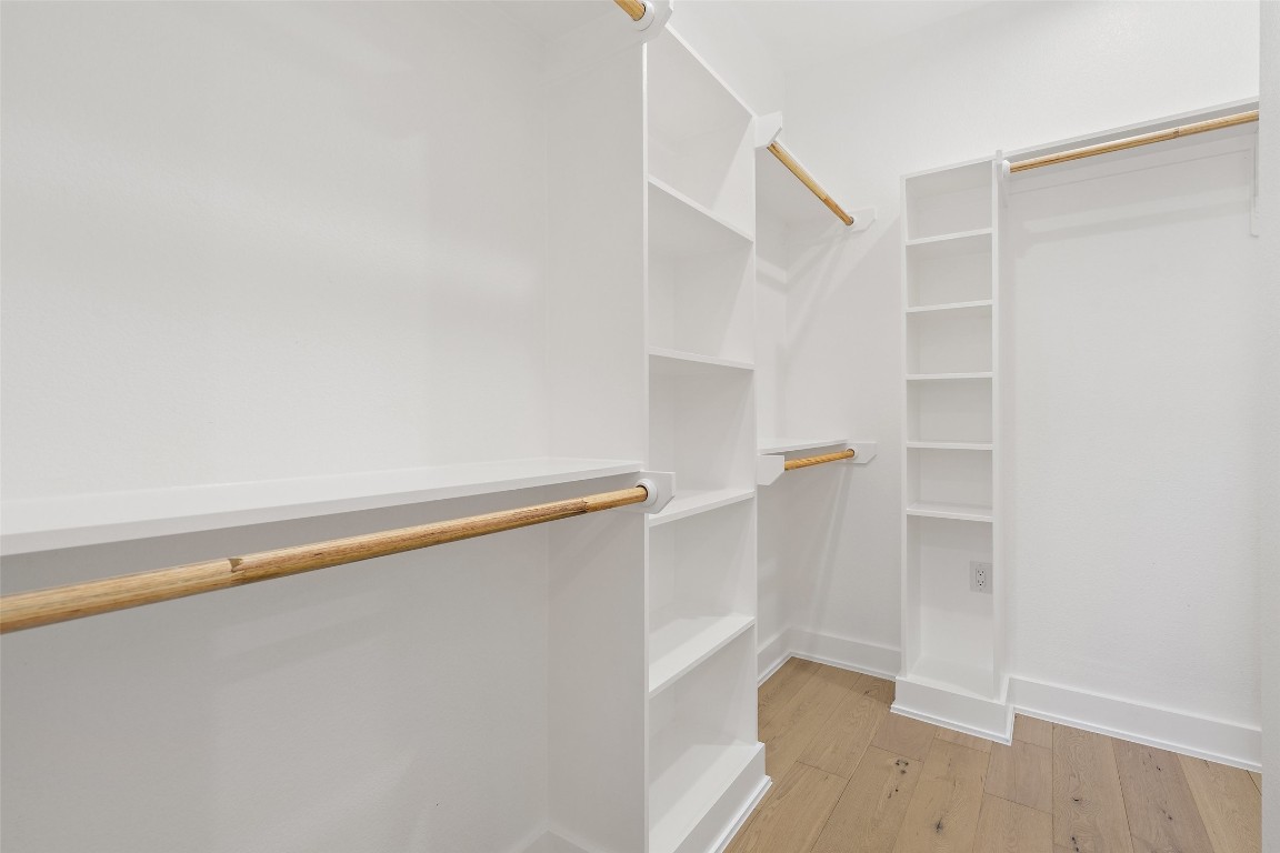 5109 Stone Gate Drive, Unit 2 Austin, TX 78721 - Photo 28 of 38 a view of walk in closet with empty racks