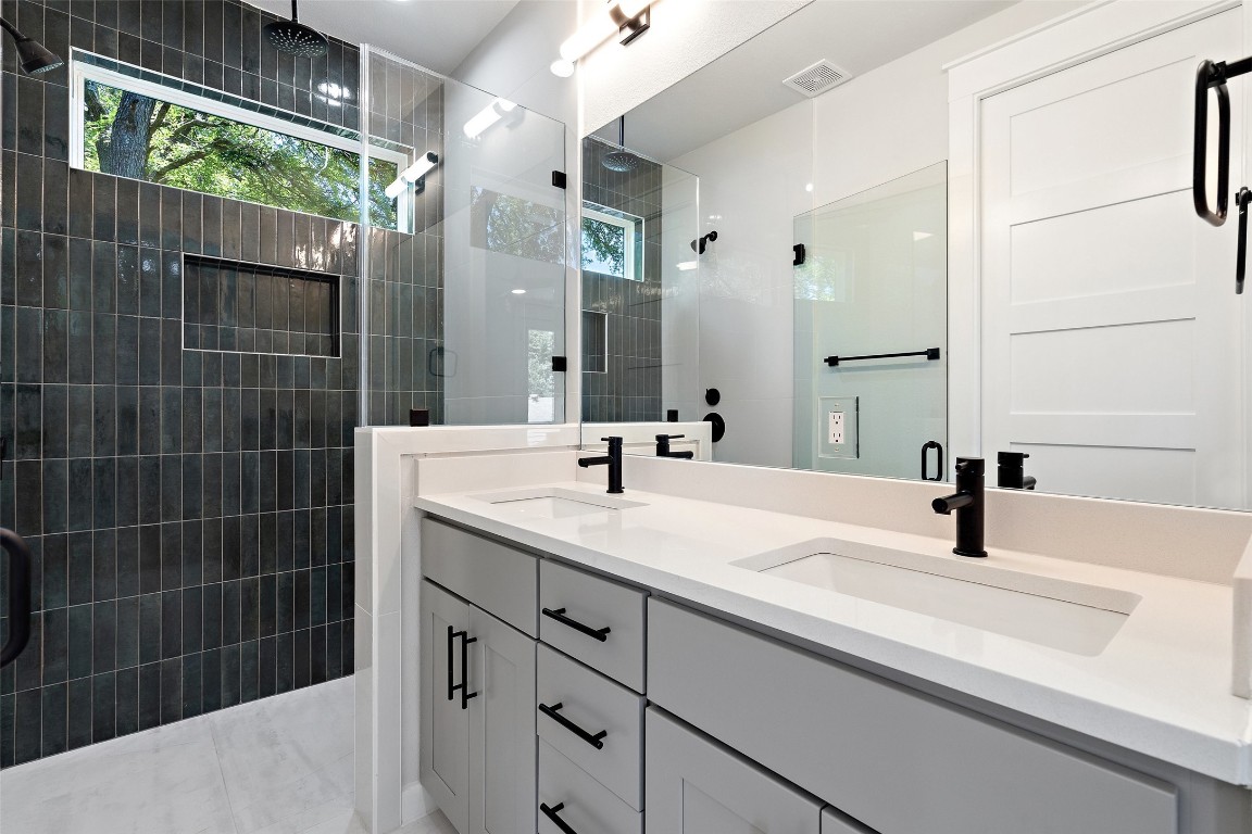 5109 Stone Gate Drive, Unit 2 Austin, TX 78721 - Photo 29 of 38 a bathroom with a sink and a mirror