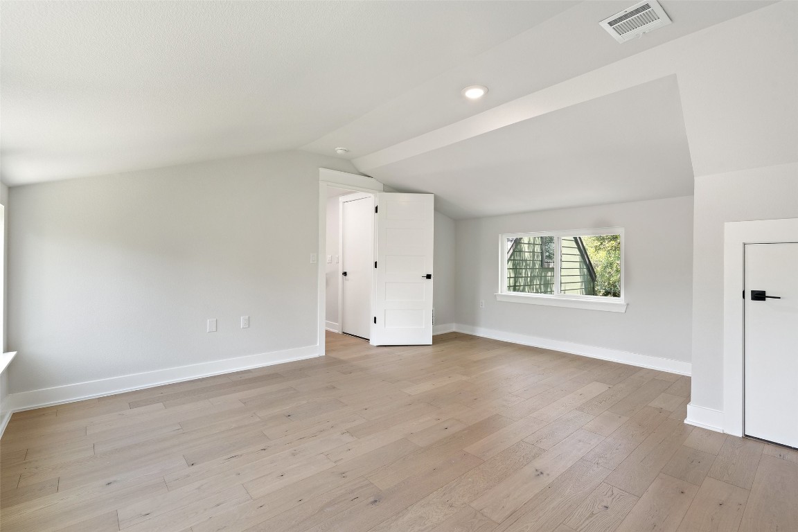5109 Stone Gate Drive, Unit 2 Austin, TX 78721 - Photo 33 of 38 an empty room with wooden floor and windows