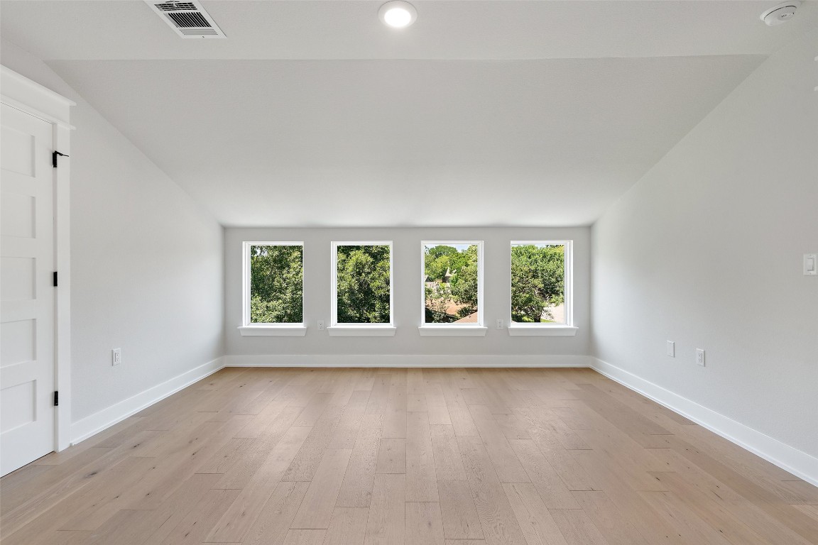 5109 Stone Gate Drive, Unit 2 Austin, TX 78721 - Photo 34 of 38 an empty room with wooden floor and windows