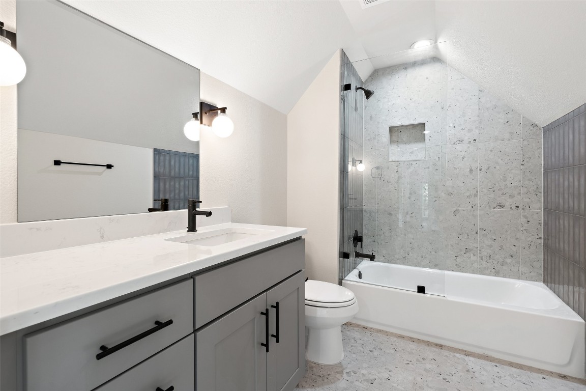5109 Stone Gate Drive, Unit 2 Austin, TX 78721 - Photo 35 of 38 a bathroom with a sink a toilet and shower