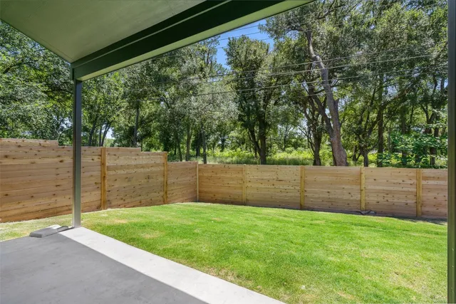 a view of a backyard with a garden and entertaining space