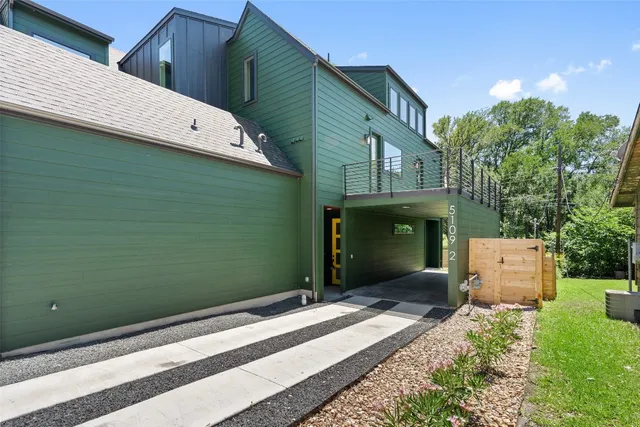 a backyard of a house with a dishwasher and a garden