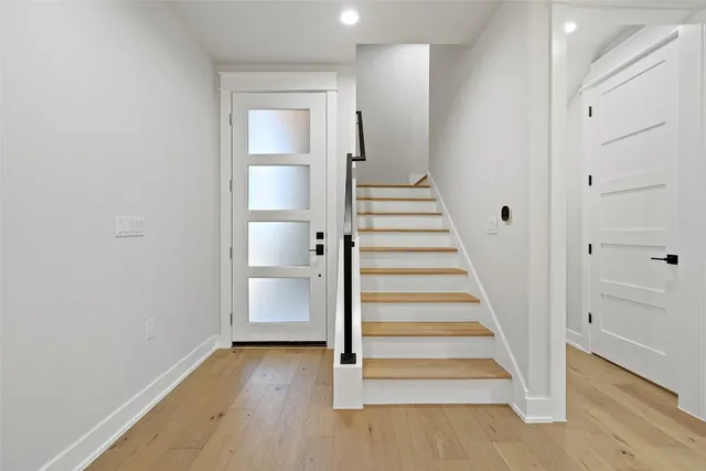a view of an entryway with wooden floor