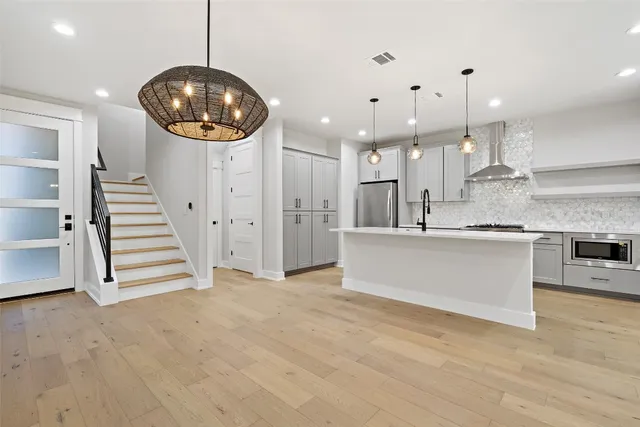 a view of kitchen and hall with a chandelier