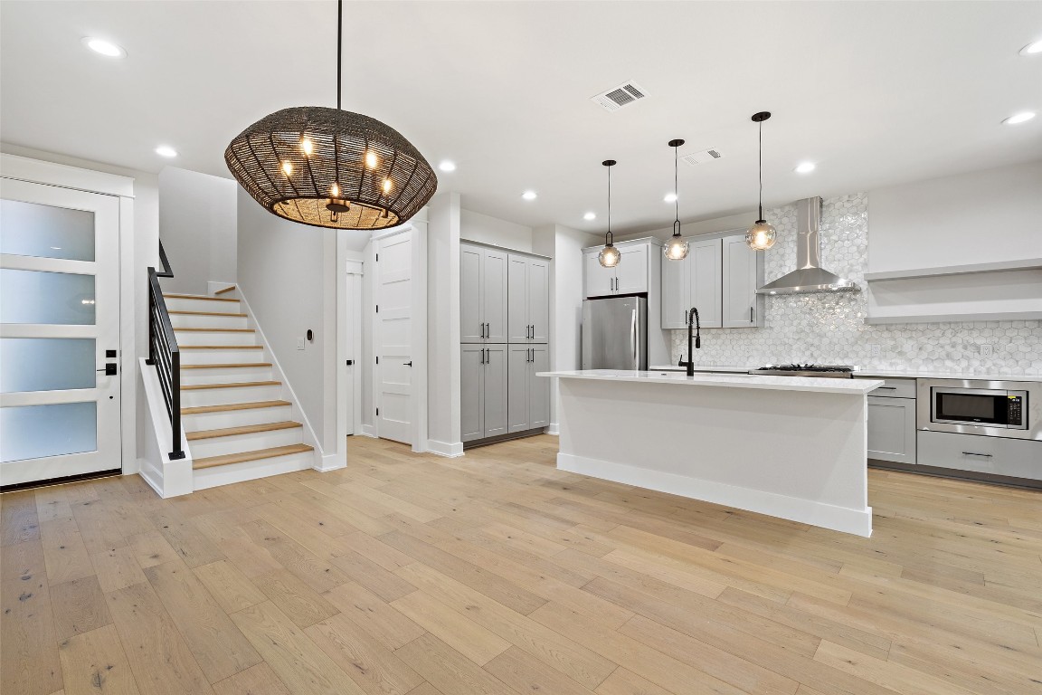 5109 Stone Gate Drive, Unit 2 Austin, TX 78721 - Photo 7 of 38 a view of kitchen and hall with a chandelier