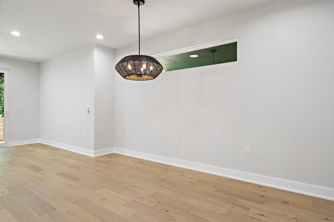 5109 Stone Gate Drive, Unit 2 Austin, TX 78721 - Photo 9 of 38 a view of a room with wooden floor and white walls