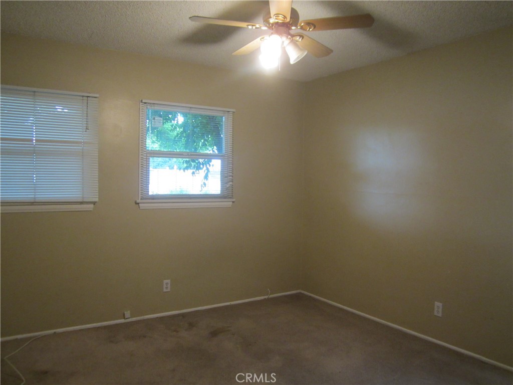 6725 De Anza Avenue Riverside, CA 92506 - Photo 20 of 25 an empty room with a window and a fan