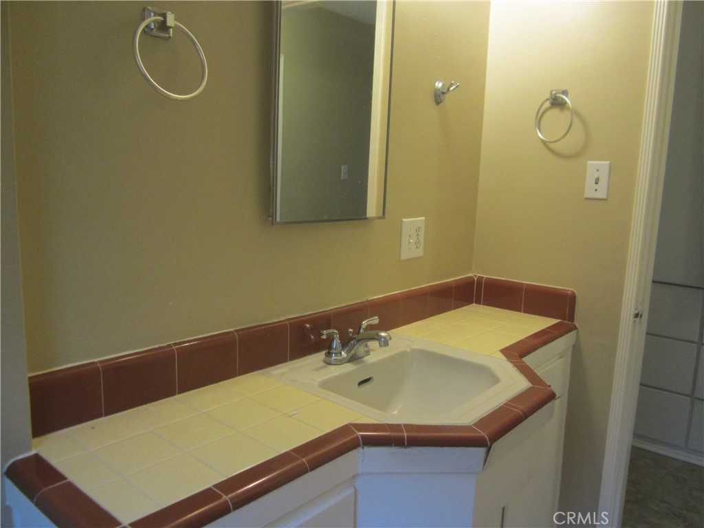 6725 De Anza Avenue Riverside, CA 92506 - Photo 22 of 25 a bathroom with a sink and a mirror