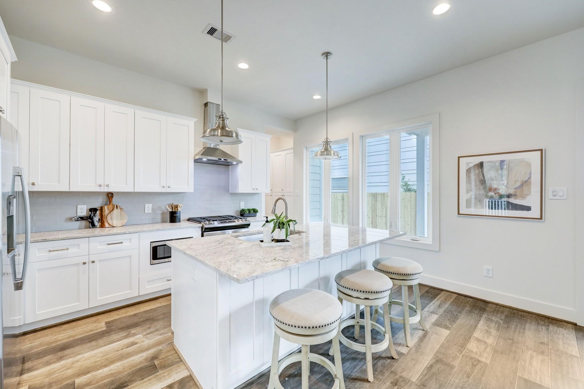 3827 Arlington Street Houston, TX 77018 - Photo 12 of 39 a large kitchen with a table and chairs