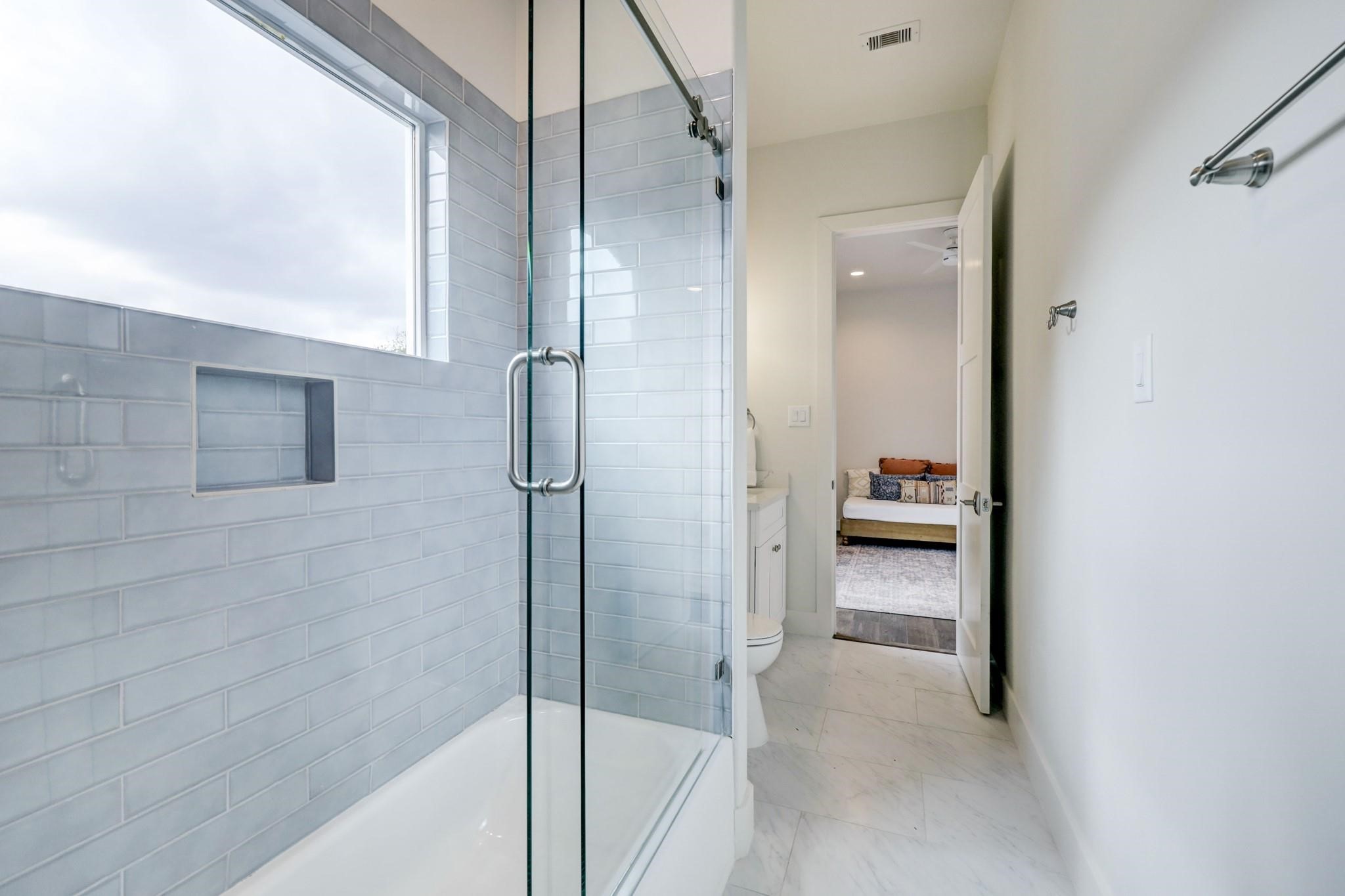 3827 Arlington Street Houston, TX 77018 - Photo 31 of 39 a bathroom with a glass shower door and a sink