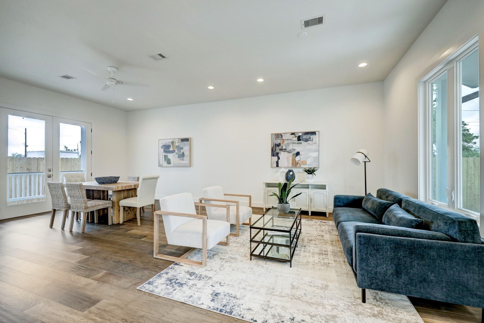 3827 Arlington Street Houston, TX 77018 - Photo 4 of 39 a living room with furniture a rug and a painting on the wall