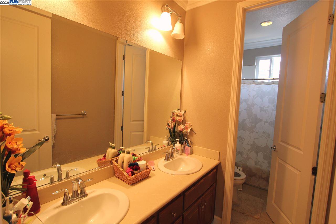 5199 Salerno Drive Dublin, CA 94568 - Photo 15 of 20 a bathroom with a double vanity sink and a mirror