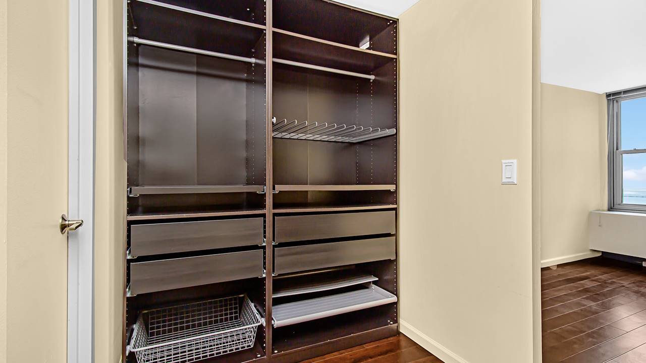 400 East Randolph Street, Unit 3321 Chicago, IL 60601 - Photo 5 of 19 a walk in closet with wooden floor