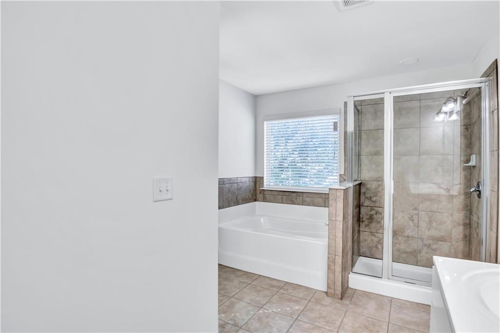 330 Avalon Square Fairburn, GA 30213 - Photo 29 of 52 a bathroom with a bathtub and shower