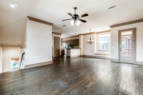 a view of a livingroom with wooden floor and a ceiling fan