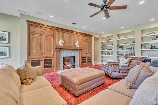 2579 Splendor Valley Road Kamas, UT 84036 - Photo 58 of 87 Living room with ceiling fan, a lit fireplace, built in features, and recessed lighting