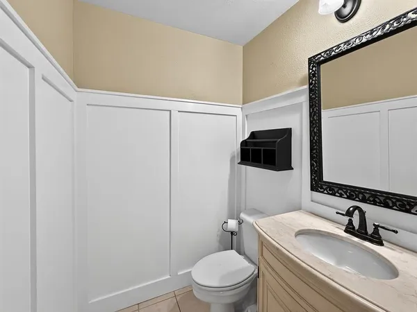 a bathroom with a sink toilet vanity and tub
