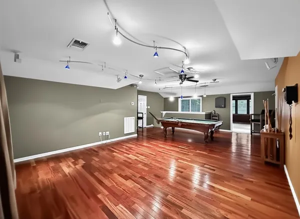 a living room with couch and a ceiling fan