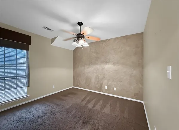 a view of an empty room with a fan