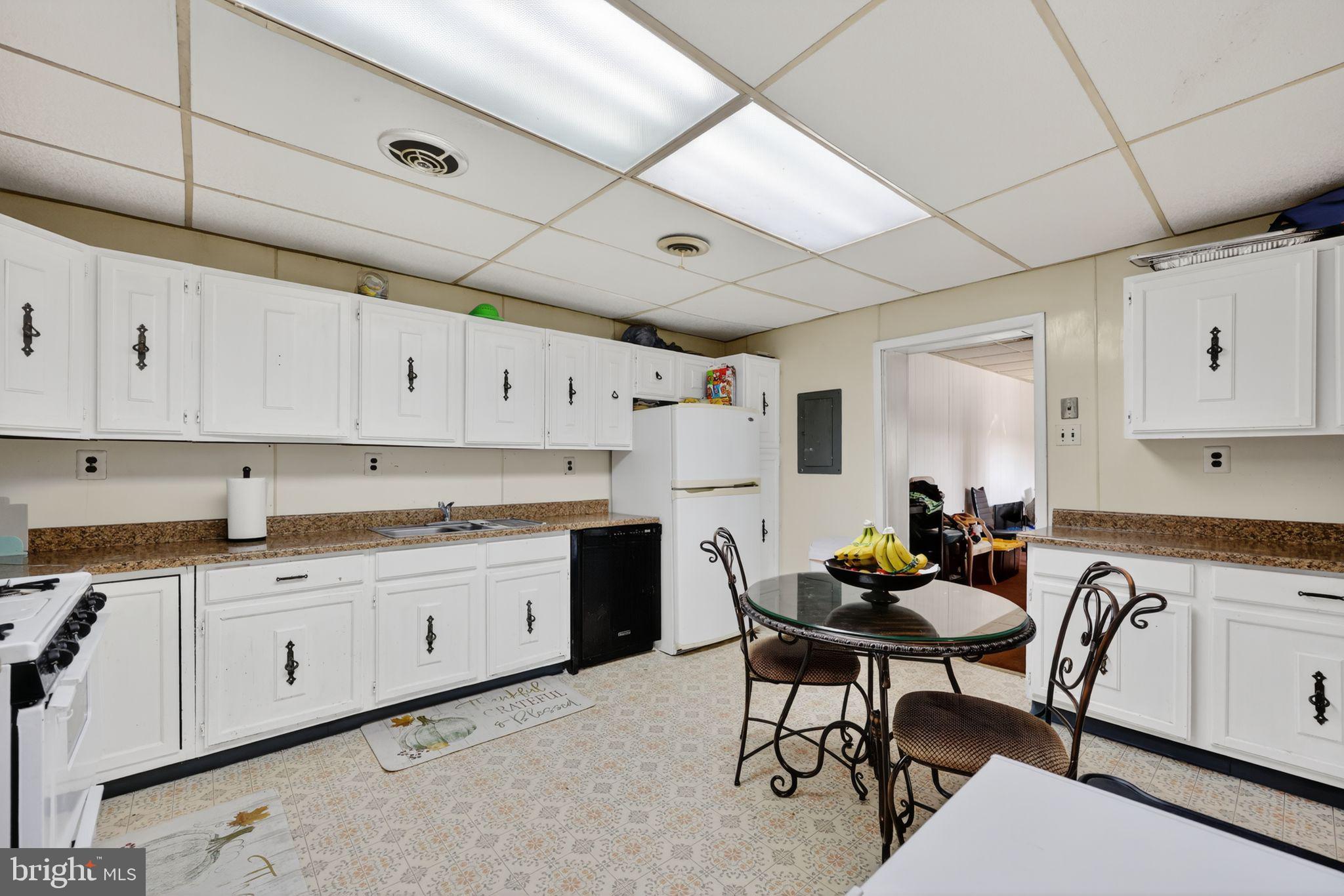 101 Main Street Roebling, NJ 08554 - Photo 20 of 55 a kitchen with cabinets appliances and a dining table