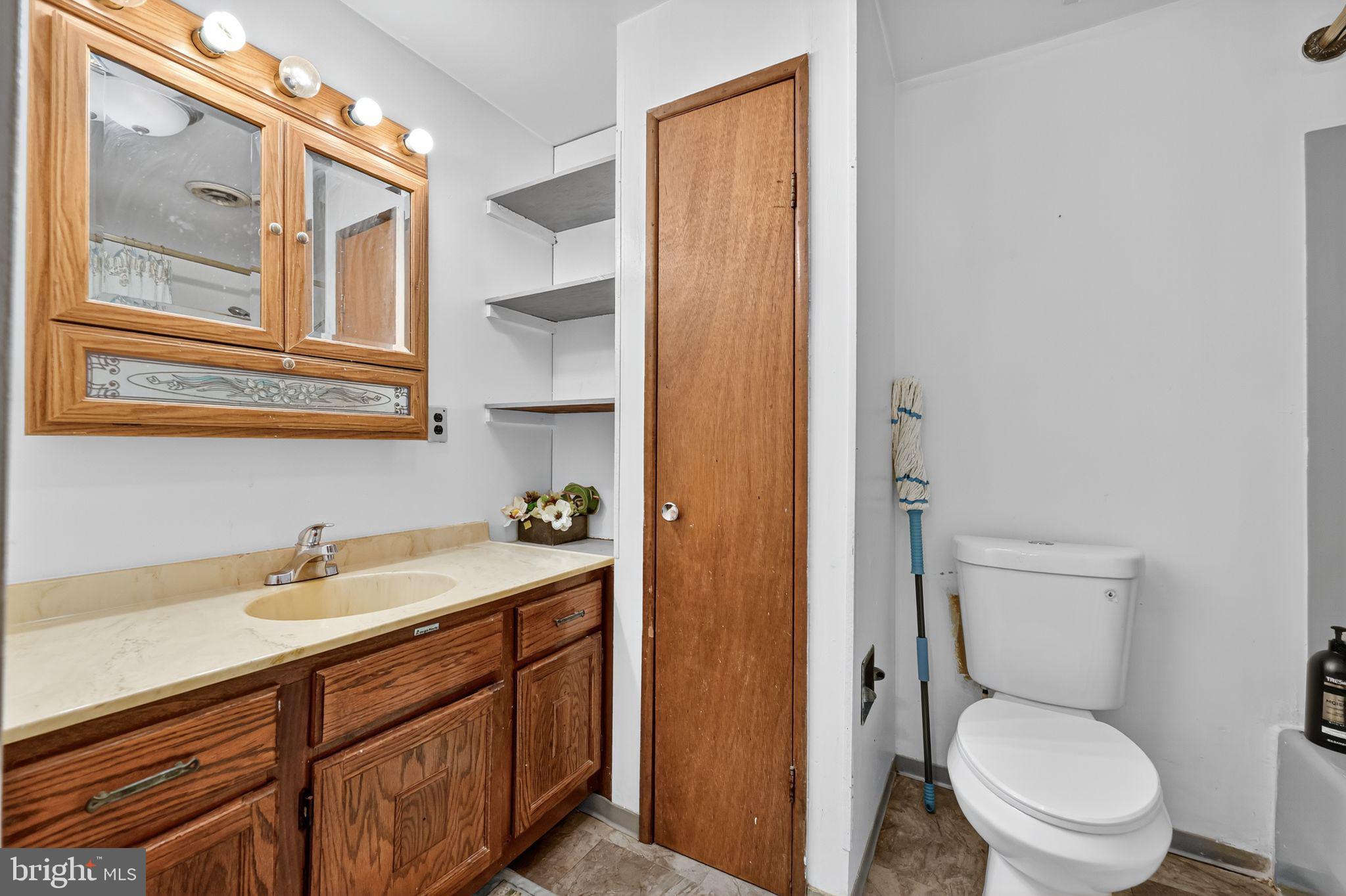 101 Main Street Roebling, NJ 08554 - Photo 26 of 55 a bathroom with a toilet a sink and mirror