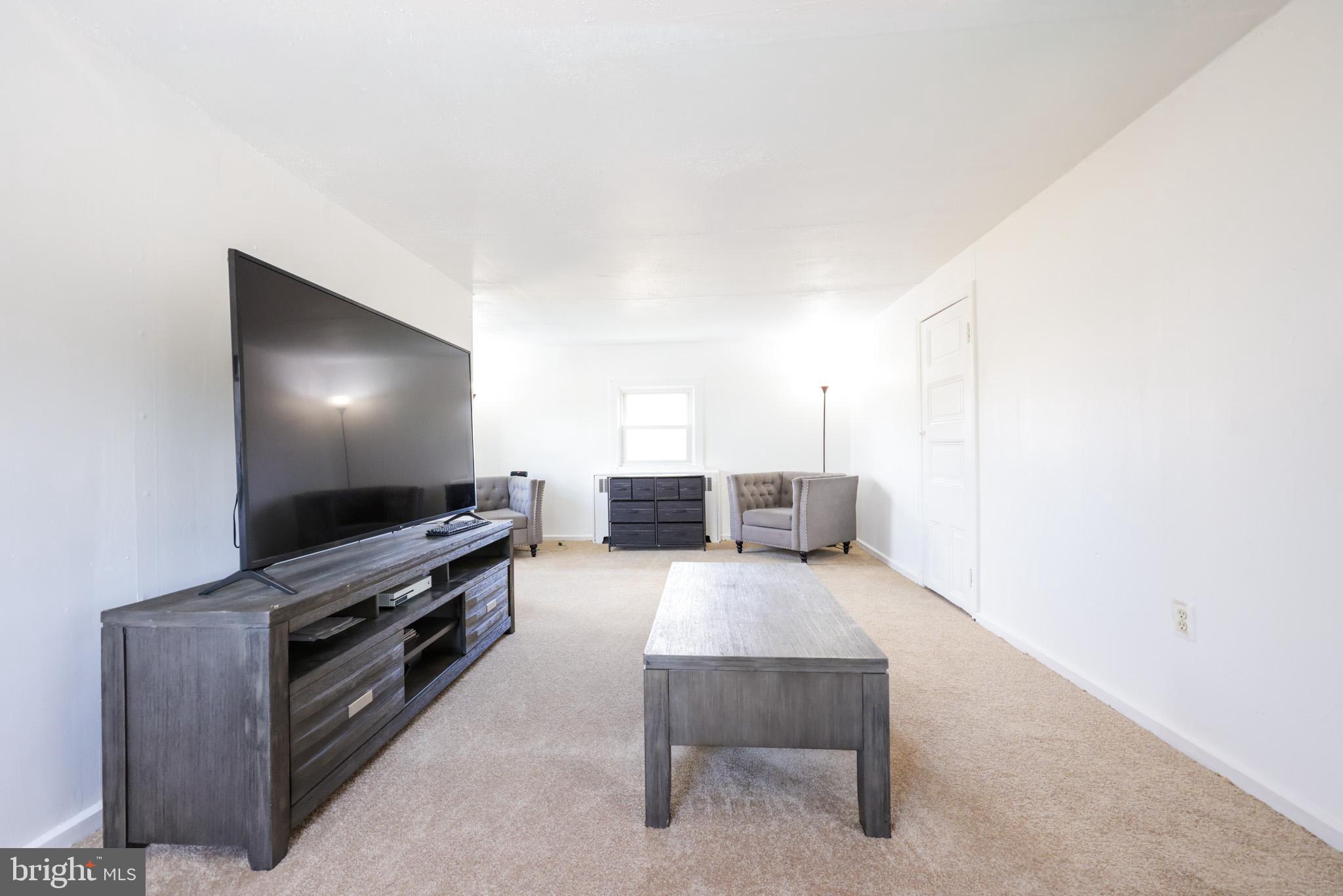 101 Main Street Roebling, NJ 08554 - Photo 30 of 55 a living room with furniture and a flat screen tv