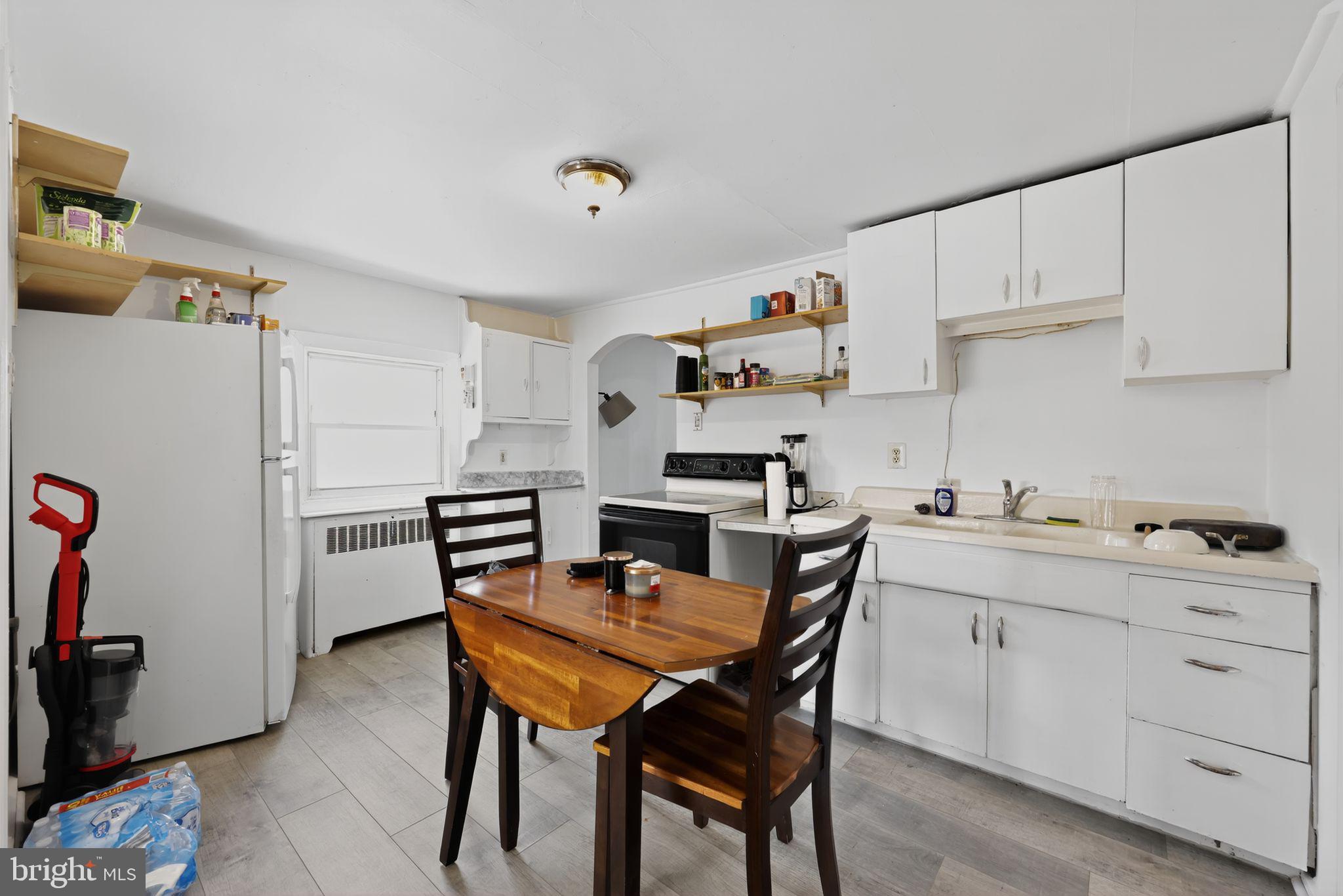 101 Main Street Roebling, NJ 08554 - Photo 33 of 55 a kitchen with a dining table chairs and refrigerator