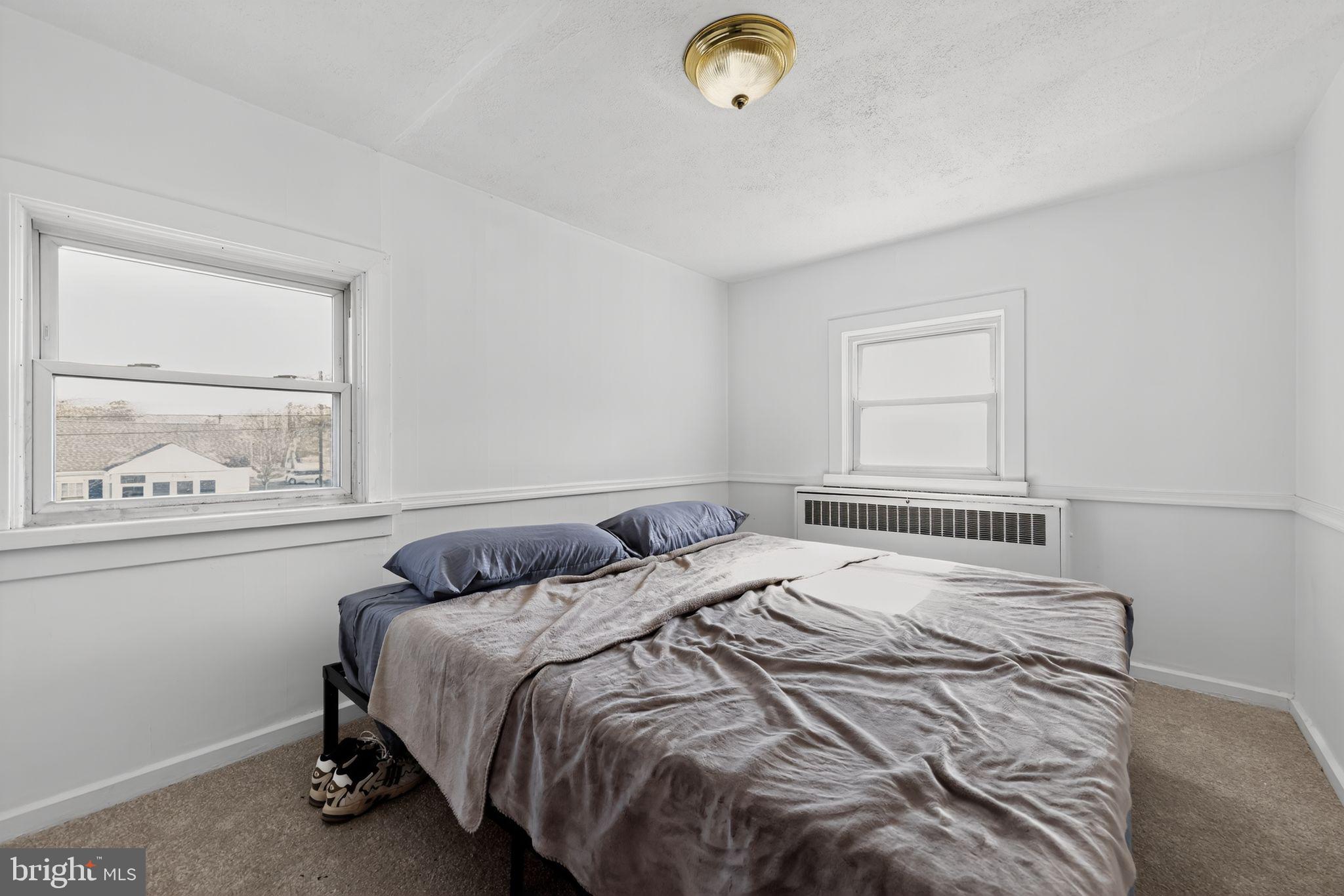 101 Main Street Roebling, NJ 08554 - Photo 35 of 55 a bedroom with a bed and window