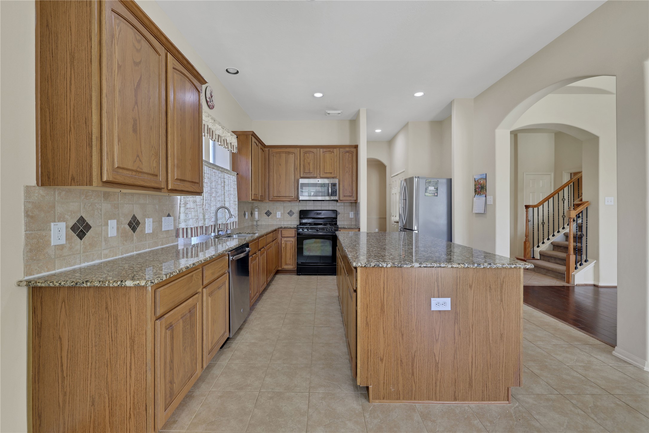 19815 Stanton Lake Drive Cypress, TX 77433 - Photo 20 of 50 a kitchen with stainless steel appliances granite countertop a refrigerator a sink and a stove