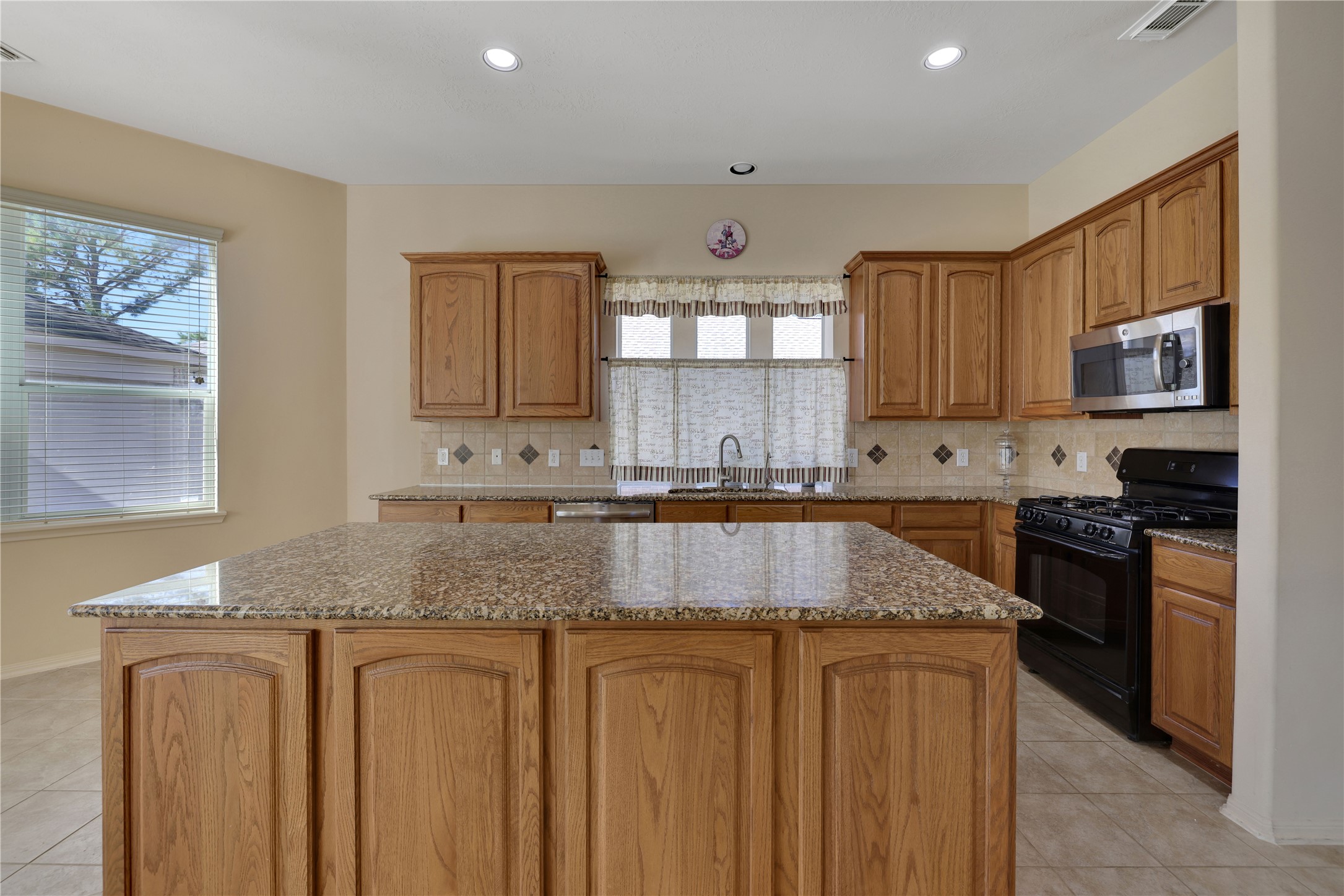19815 Stanton Lake Drive Cypress, TX 77433 - Photo 21 of 50 a kitchen with granite countertop a sink stove and cabinets