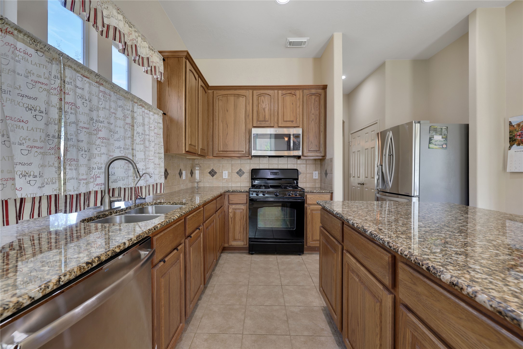 19815 Stanton Lake Drive Cypress, TX 77433 - Photo 23 of 50 a kitchen with granite countertop a sink stove and cabinets