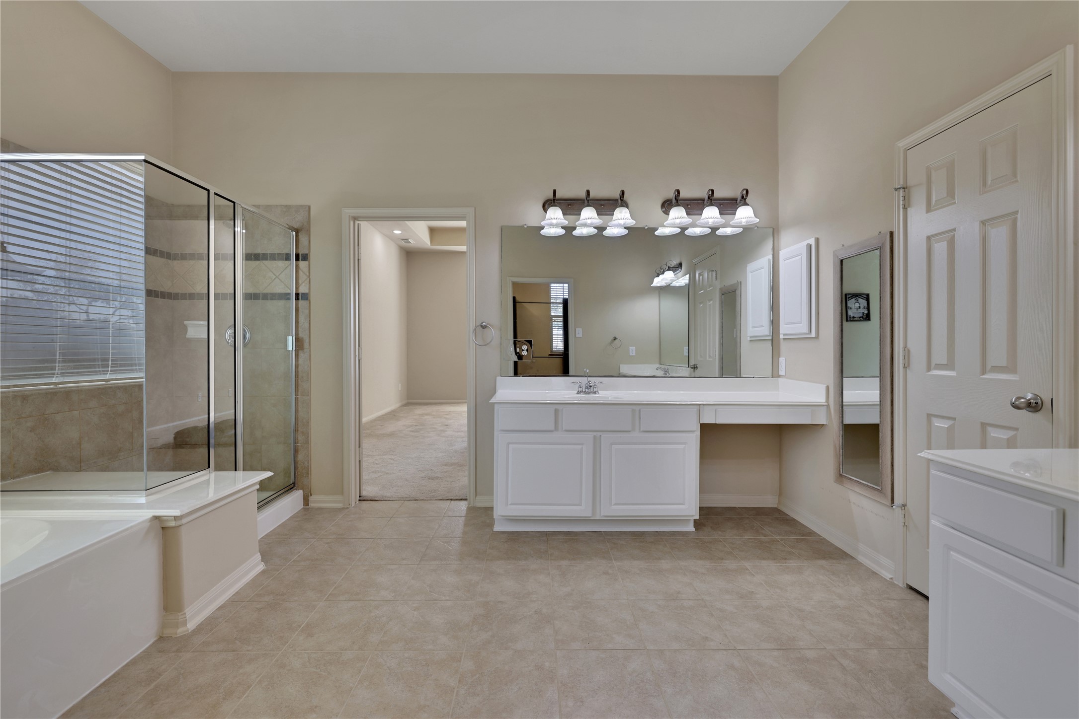19815 Stanton Lake Drive Cypress, TX 77433 - Photo 28 of 50 a spacious bathroom with a double vanity sink a large mirror and a bathtub