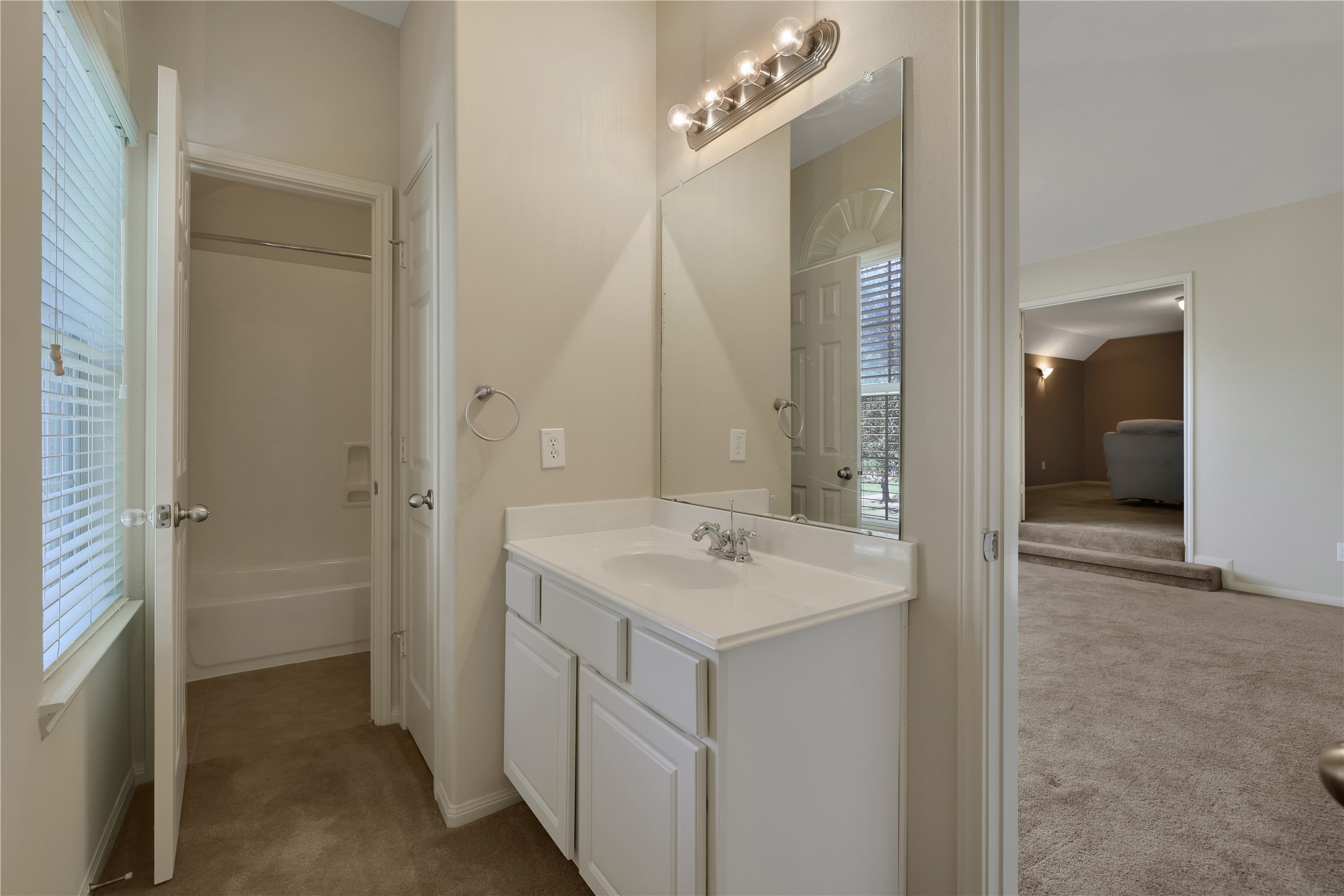 19815 Stanton Lake Drive Cypress, TX 77433 - Photo 34 of 50 a view of a bathroom with a sink mirror and shower