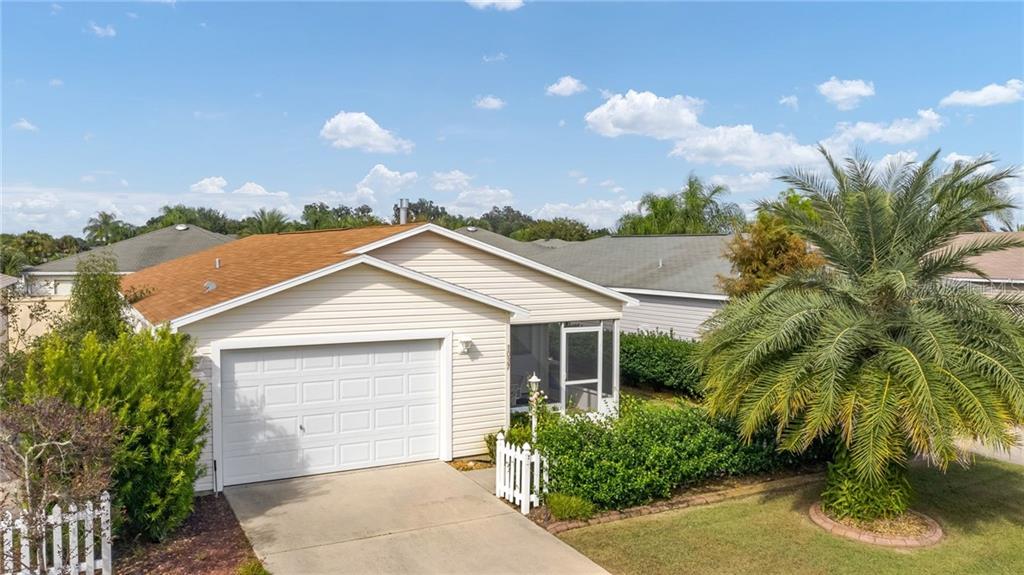 1037 Ridgeville Road The Villages, FL 32162 - Photo 1 of 1 a view of a house with a small yard and palm trees