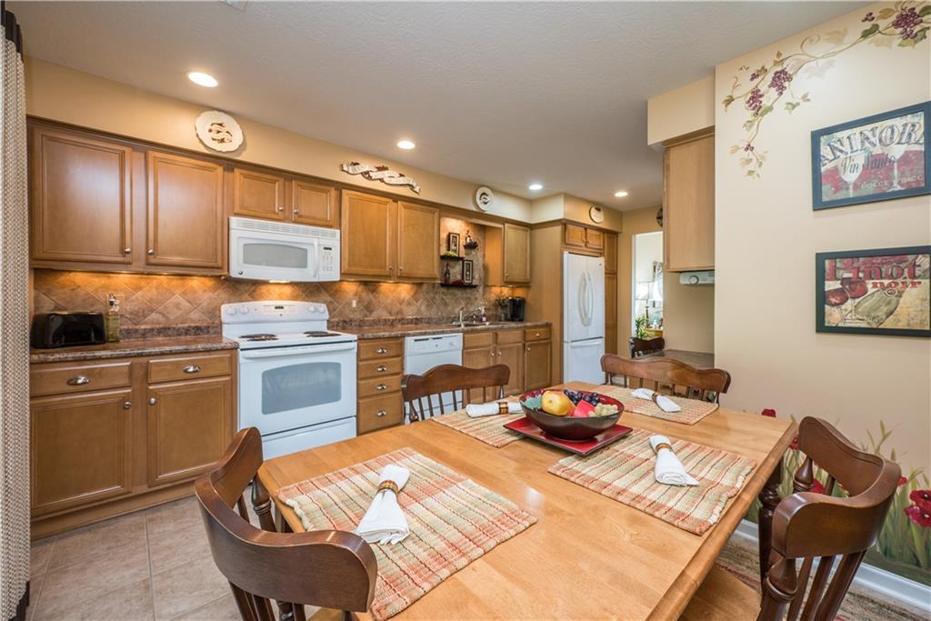 5534 Lantern Hill Extension Pittsburgh, PA 15236 - Photo 13 of 33 a kitchen with a table chairs stove and refrigerator