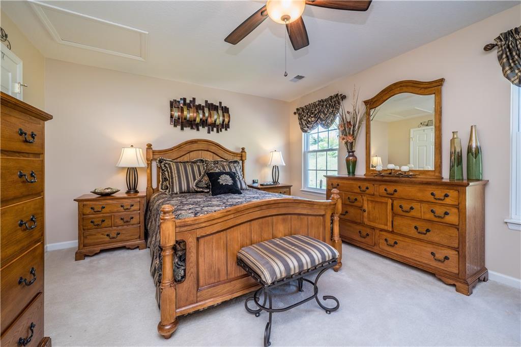 5534 Lantern Hill Extension Pittsburgh, PA 15236 - Photo 23 of 33 a bedroom with a bed and a chandelier