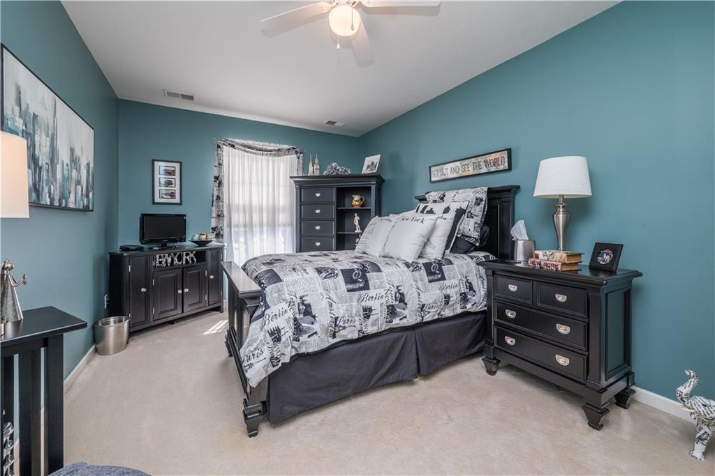 5534 Lantern Hill Extension Pittsburgh, PA 15236 - Photo 25 of 33 a bedroom with a bed a lamp and a chandelier