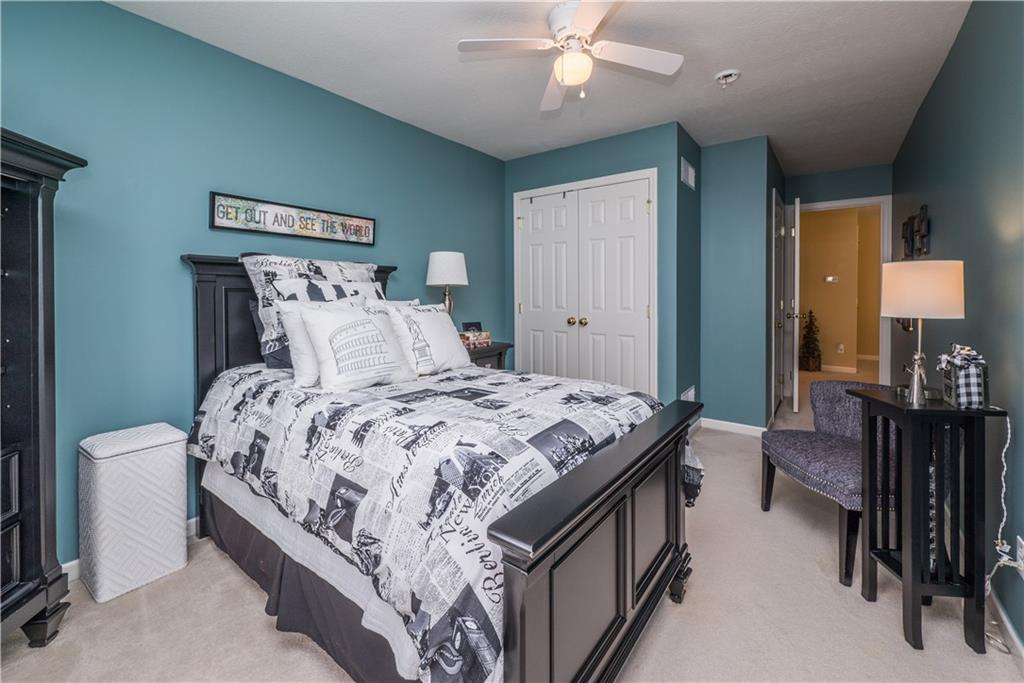 5534 Lantern Hill Extension Pittsburgh, PA 15236 - Photo 26 of 33 a bedroom with a bed and a chandelier