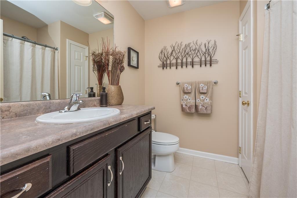 5534 Lantern Hill Extension Pittsburgh, PA 15236 - Photo 27 of 33 a bathroom with a granite countertop sink a toilet and a mirror