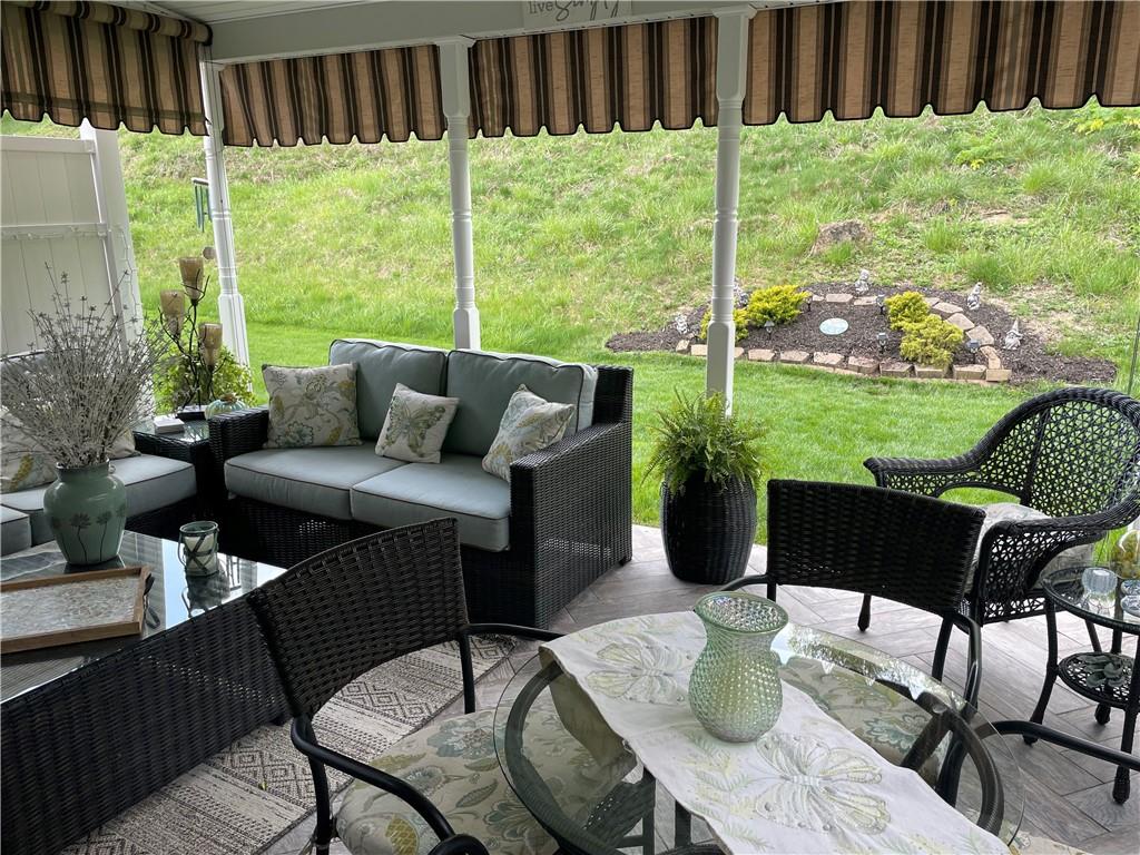 5534 Lantern Hill Extension Pittsburgh, PA 15236 - Photo 30 of 33 a view of a patio with couches chairs potted plants and a yard with wooden floor