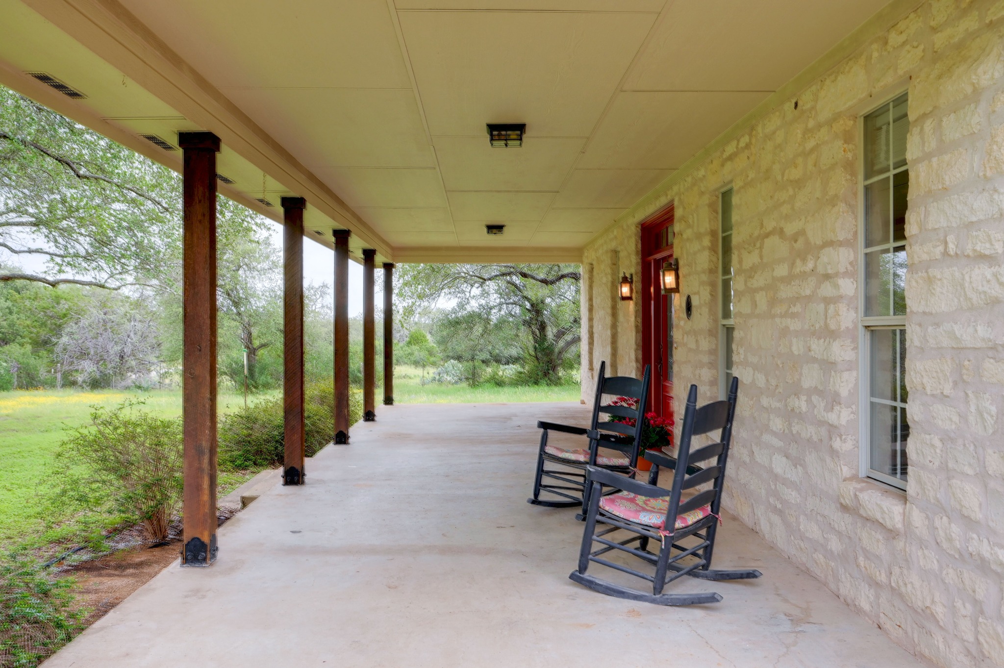364 Nameless Road Driftwood, TX 78619 - Photo 7 of 32 Relax on this expansive porch, offering serene views of nature. A lot of front porch nature watching going on here.
