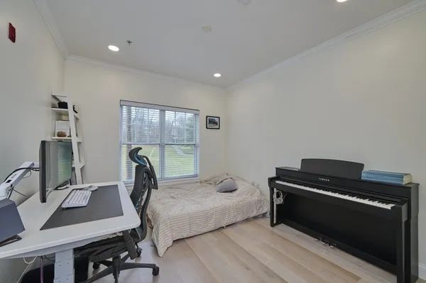a bedroom with a bed and a desk