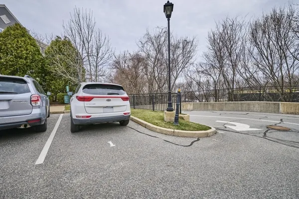 a view of a street with a car parked on the road