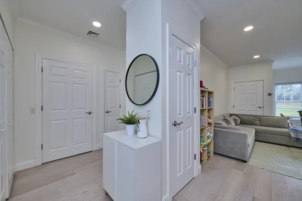a living room with furniture and a mirror