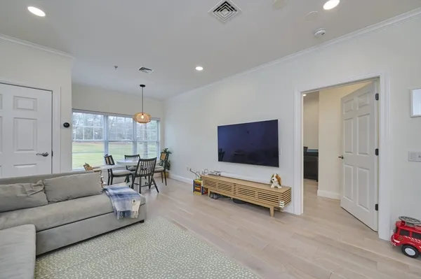 a living room with furniture gym equipment and a flat screen tv