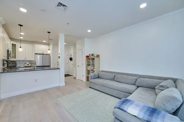 a living room with furniture and kitchen view