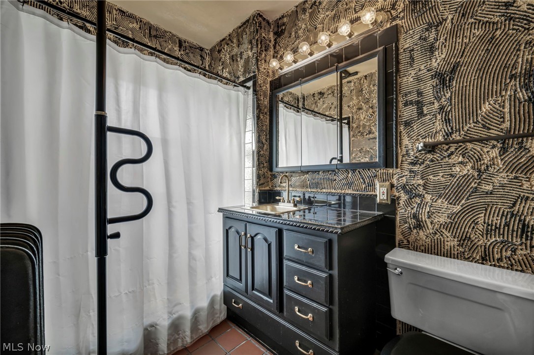 3272 Tullamore Road Cleveland, OH 44118 - Photo 40 of 47 Bathroom featuring wallpapered walls, vanity, curtained shower, and dark tile patterned flooring