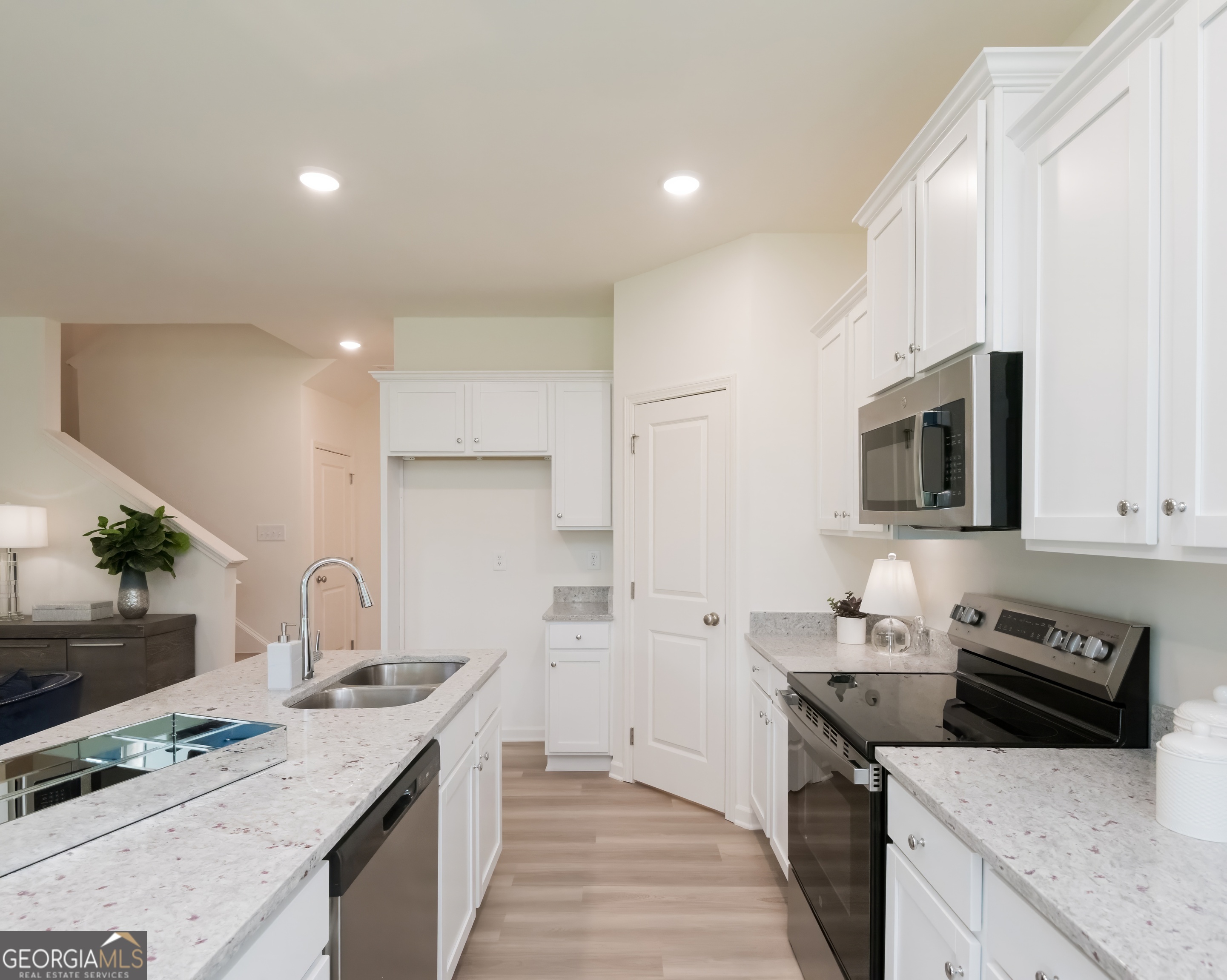 2553 Riverside Court Northeast Conyers, GA 30013 - Photo 13 of 40 a kitchen with stainless steel appliances granite countertop a sink stove and refrigerator