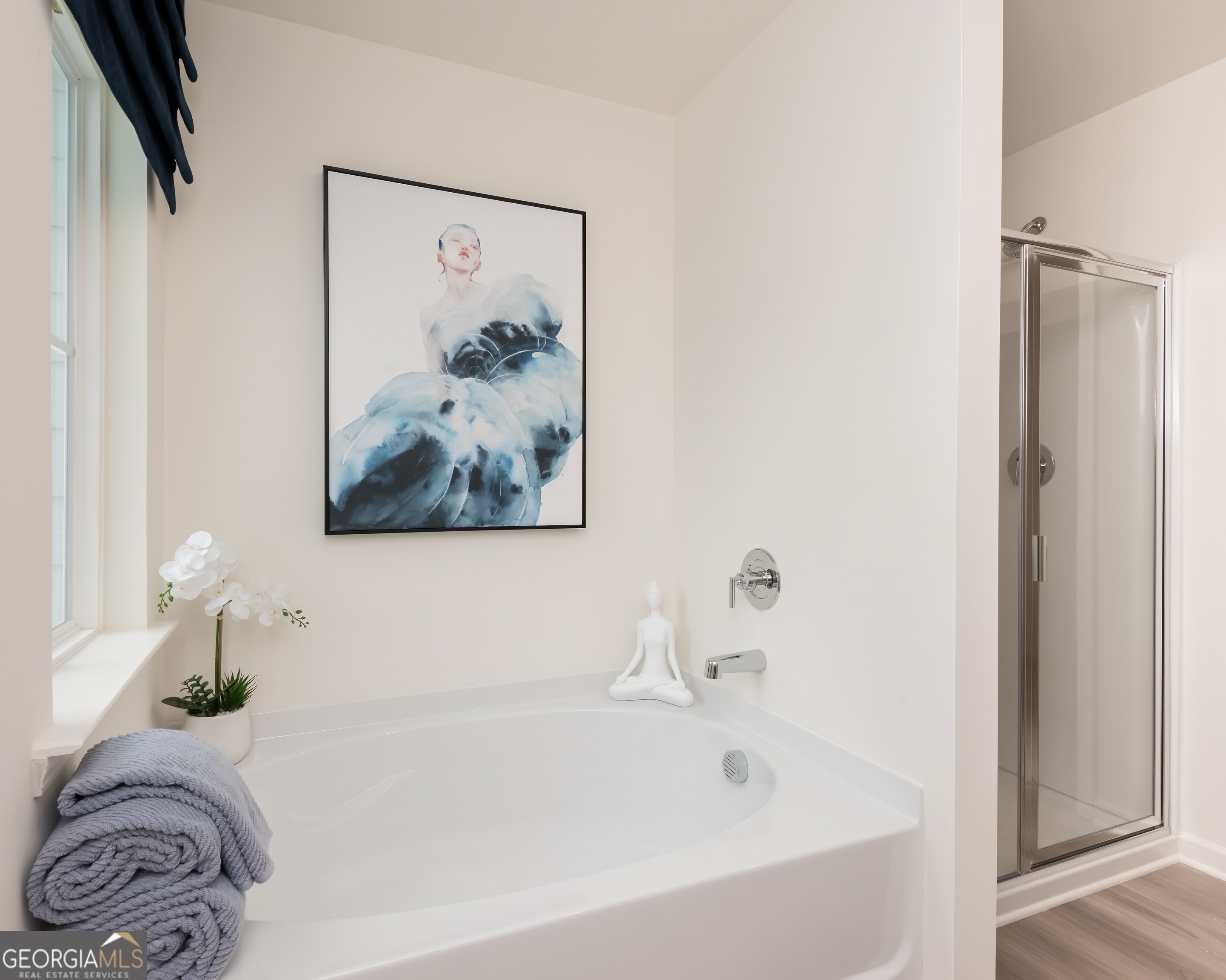2553 Riverside Court Northeast Conyers, GA 30013 - Photo 23 of 40 a bath tub sitting next to a white sink and vanity
